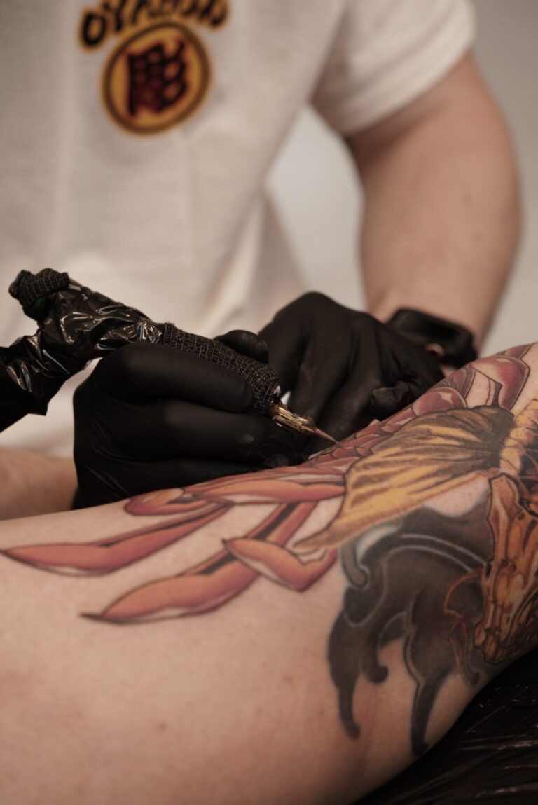 Closeup of Malin tattooing back of the knee
