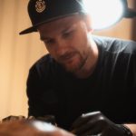 Tattoo artist during work artistic light