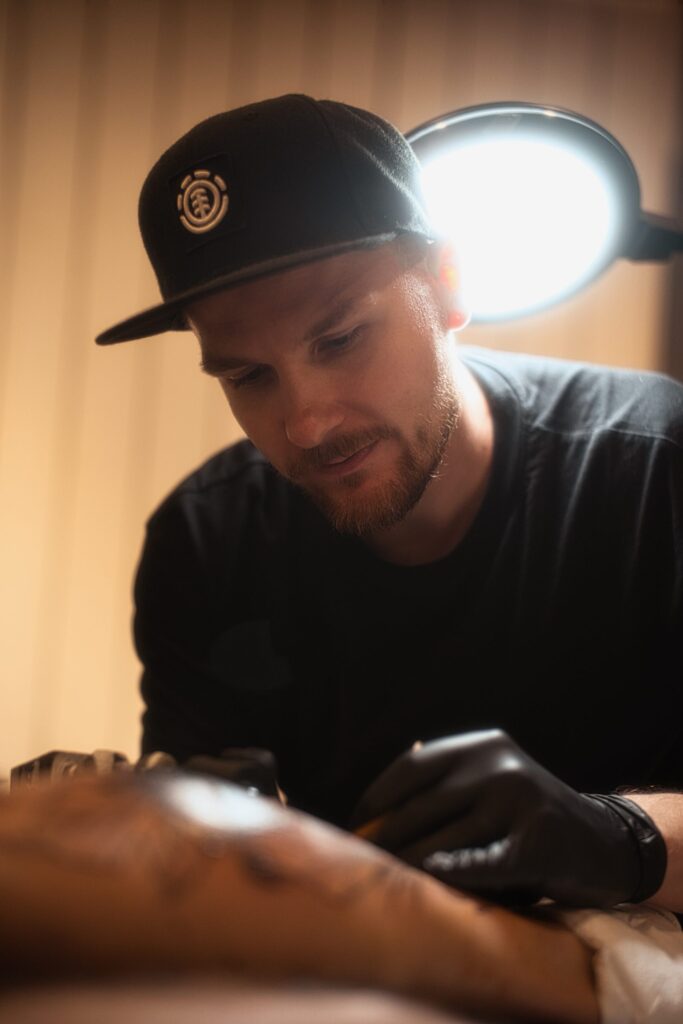 Tattoo artist during work artistic light